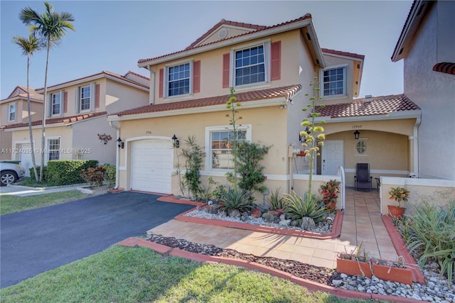 mediterranean / spanish-style home with a garage