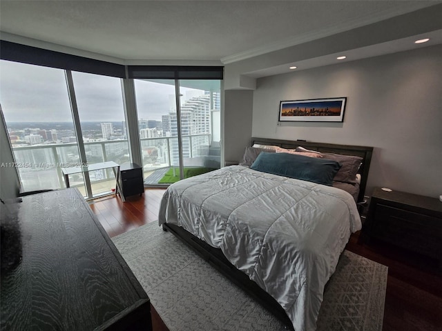 bedroom featuring access to exterior, wood-type flooring, and ornamental molding