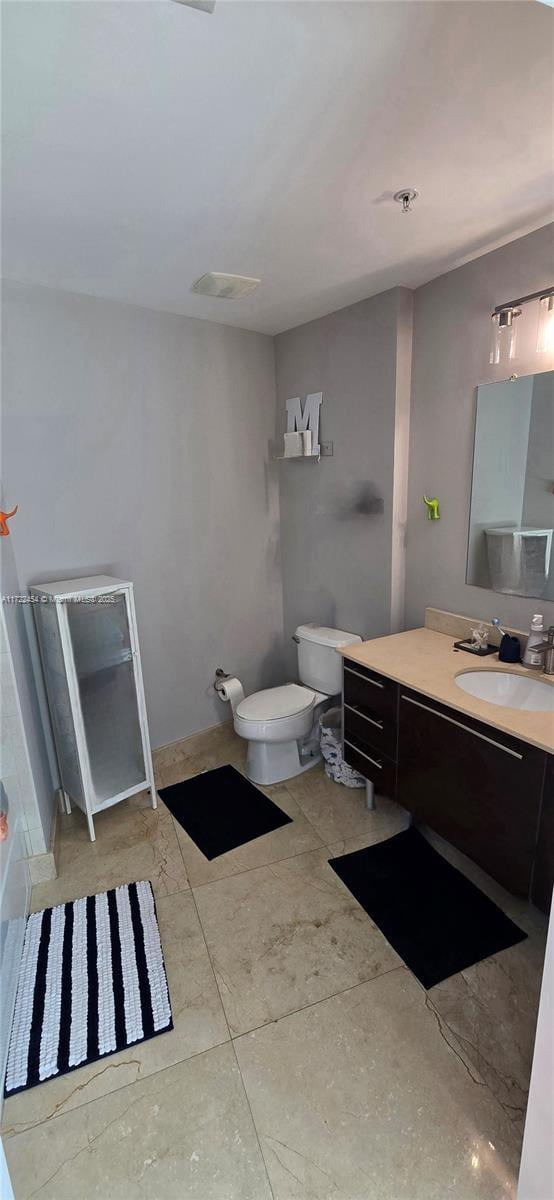 bathroom featuring vanity and toilet