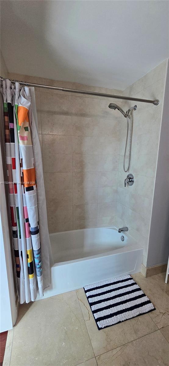 bathroom featuring shower / tub combo and tile patterned floors