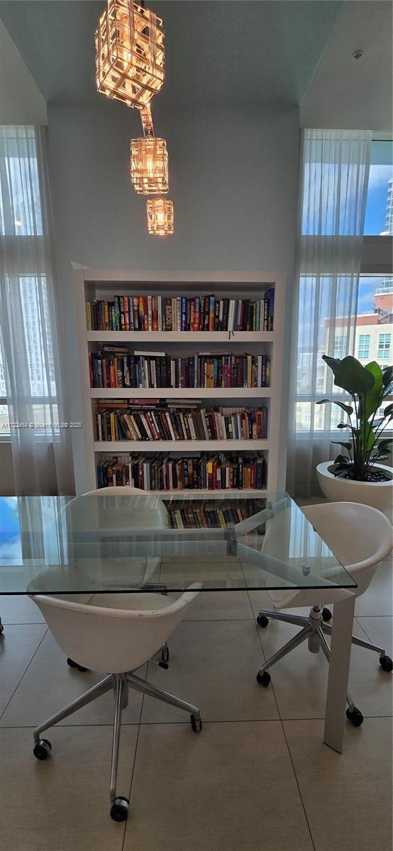 office area with built in shelves and tile patterned flooring