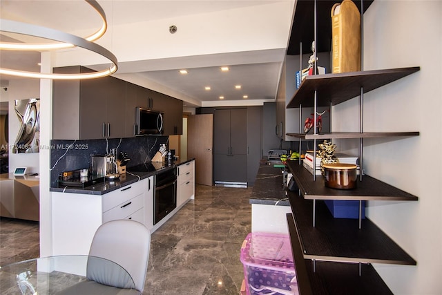 kitchen with black appliances, white cabinets, and backsplash