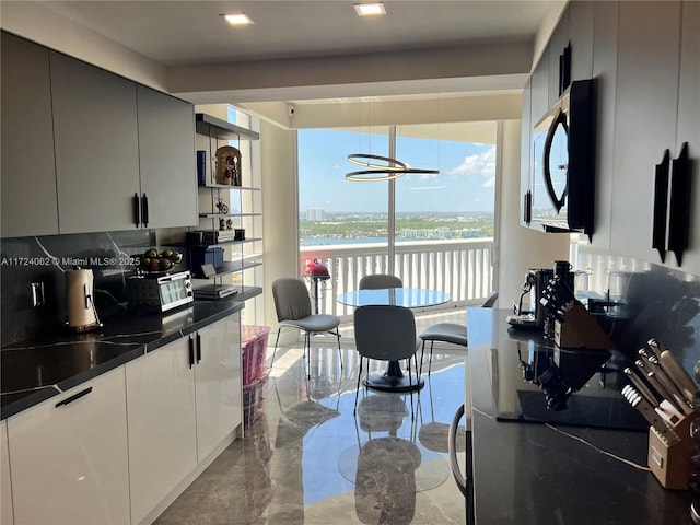 kitchen with decorative backsplash and a water view