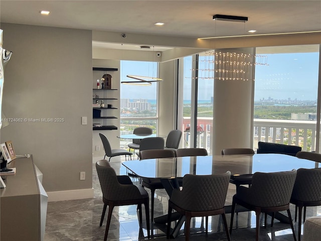 dining room with a water view and a healthy amount of sunlight