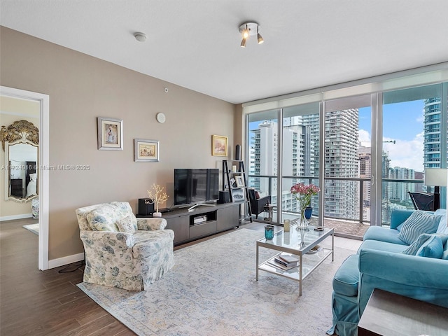 living room featuring expansive windows and hardwood / wood-style flooring