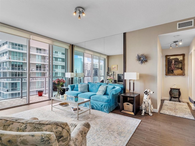 living room with floor to ceiling windows and dark wood-type flooring