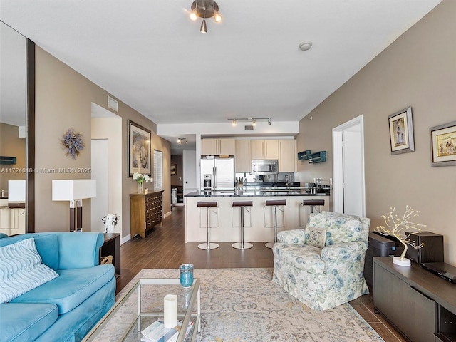 living room with dark hardwood / wood-style flooring