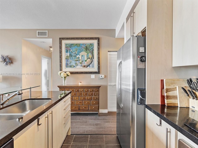 kitchen featuring appliances with stainless steel finishes, a textured ceiling, and sink