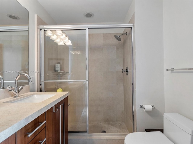 bathroom with an enclosed shower, vanity, and toilet