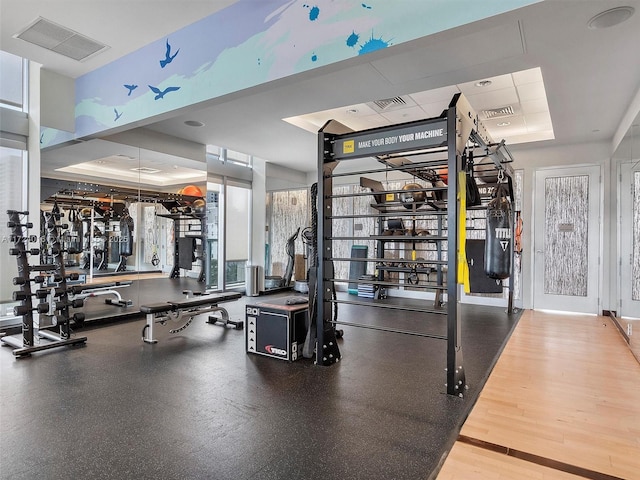 gym featuring a tray ceiling