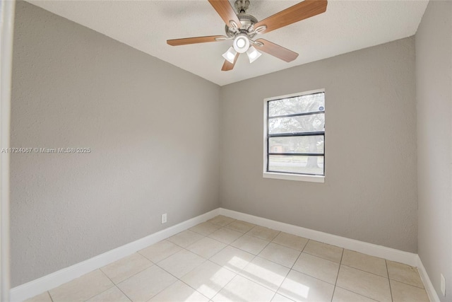 empty room with light tile patterned flooring and ceiling fan