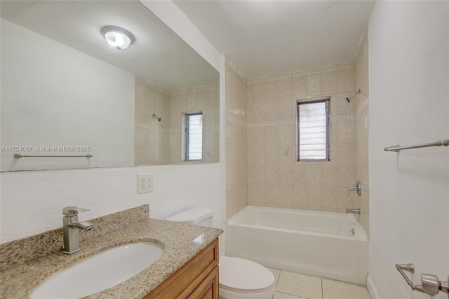 full bathroom featuring tiled shower / bath, tile patterned floors, toilet, and vanity