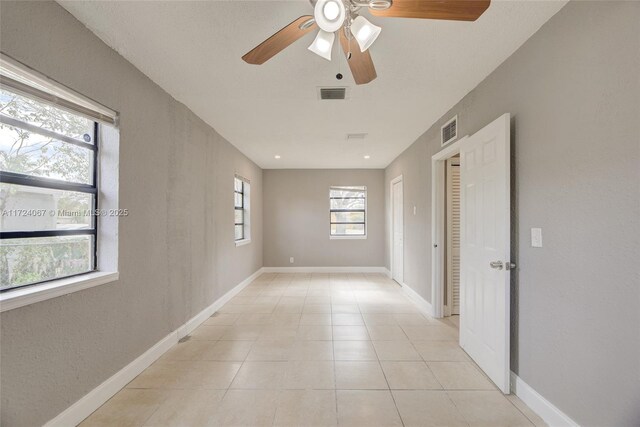 spare room with light tile patterned floors and ceiling fan