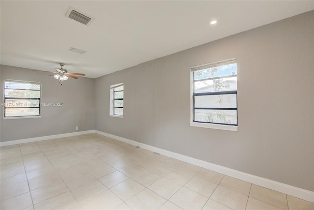 unfurnished room with a wealth of natural light and ceiling fan