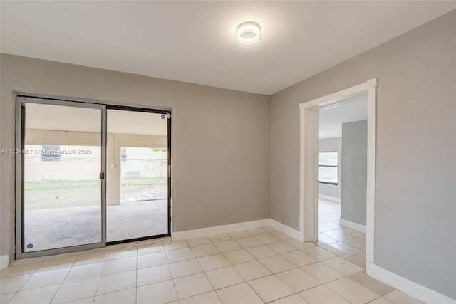 spare room with light tile patterned floors