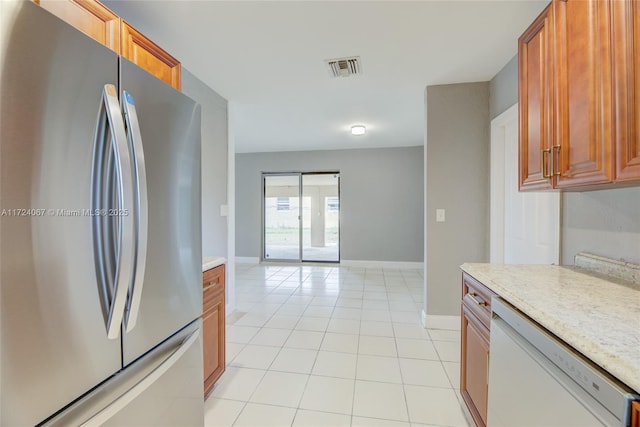 kitchen featuring light tile patterned flooring, stainless steel fridge, and white dishwasher