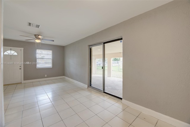 unfurnished room with light tile patterned flooring and ceiling fan