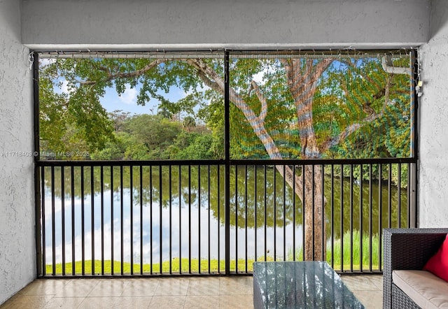 unfurnished sunroom featuring a water view