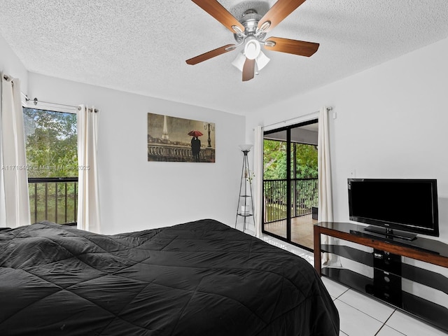 tiled bedroom featuring ceiling fan, a textured ceiling, and access to outside