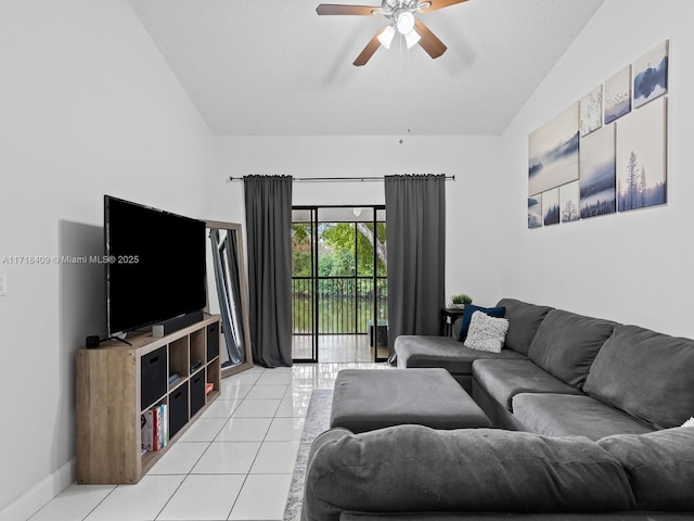 tiled living room with ceiling fan, a textured ceiling, and lofted ceiling