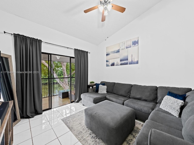 living room featuring ceiling fan, light tile patterned flooring, and vaulted ceiling