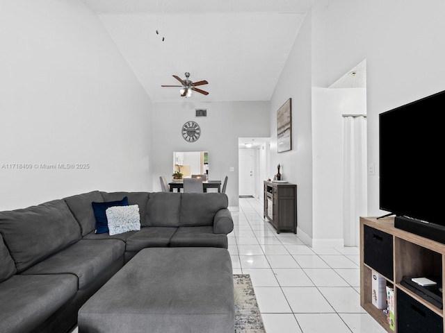 living room with ceiling fan, high vaulted ceiling, and light tile patterned flooring