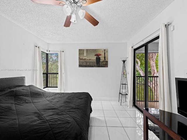 tiled bedroom featuring a textured ceiling, ceiling fan, access to exterior, and multiple windows