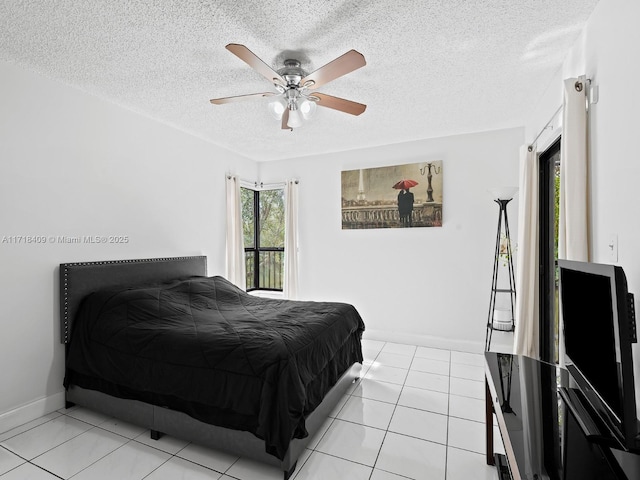 bedroom featuring a textured ceiling, ceiling fan, and light tile patterned floors