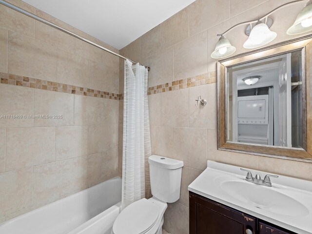 3868 N Carambola Cir N Unit 2961, Coconut Creek, FL 33066 - full bathroom with stacked washer and clothes dryer, tile walls, vanity, shower / bath combo with shower curtain, and toilet