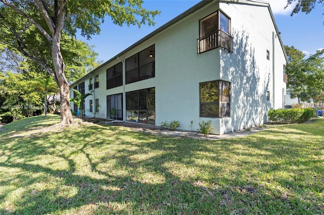 rear view of property featuring a yard