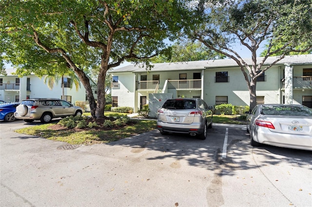 3868 N Carambola Cir N Unit 2961, Coconut Creek, FL 33066 - townhome / multi-family property with uncovered parking, stucco siding, and stairway