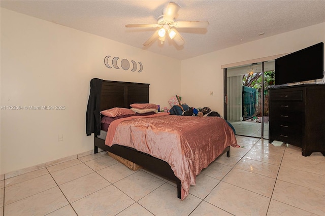 bedroom featuring ceiling fan, light tile patterned flooring, a textured ceiling, and access to outside