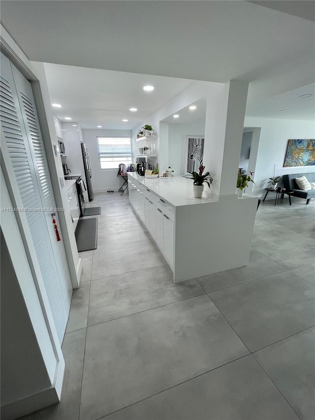 kitchen featuring stainless steel appliances and white cabinetry