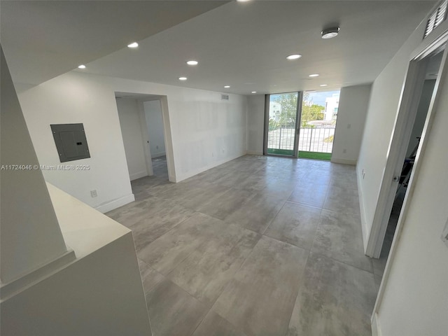 empty room featuring electric panel and expansive windows