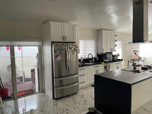 kitchen featuring white cabinets, range hood, sink, and appliances with stainless steel finishes