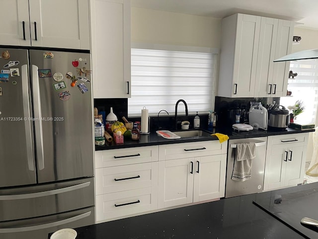 kitchen with white cabinetry, sink, stainless steel appliances, and plenty of natural light