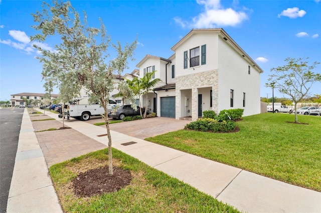 view of front of home featuring a garage and a front yard