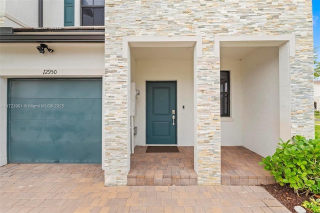 view of exterior entry featuring a garage