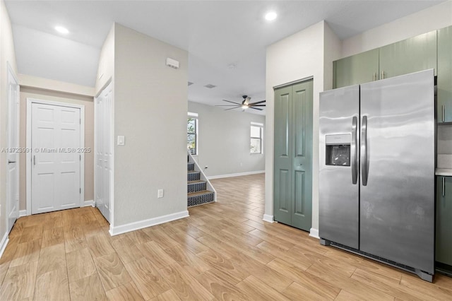 kitchen with green cabinets, stainless steel fridge, ceiling fan, and light hardwood / wood-style floors