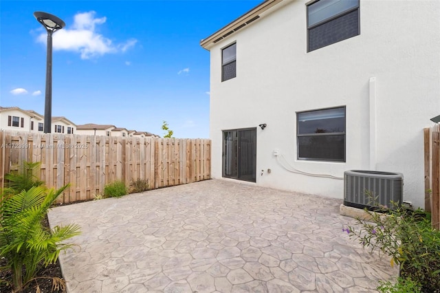 exterior space with a patio area and central air condition unit