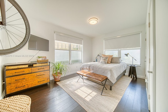 bedroom with dark wood-type flooring