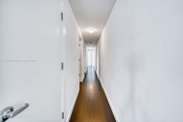 corridor featuring dark hardwood / wood-style flooring