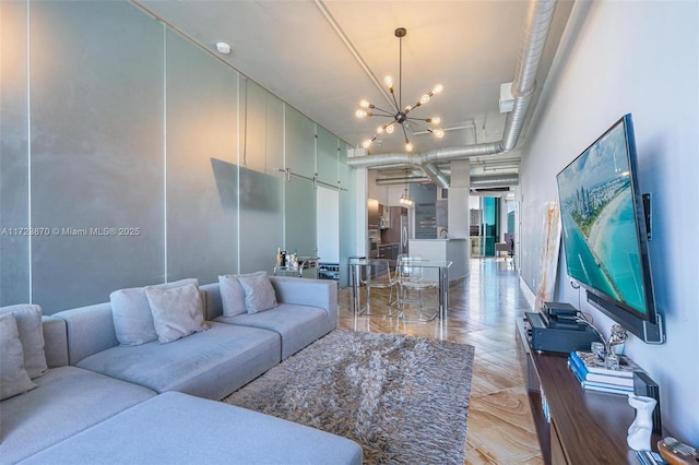 living room featuring an inviting chandelier and a towering ceiling