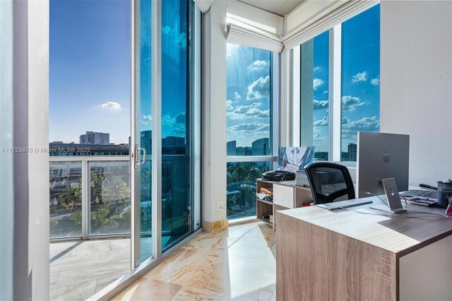 office area with plenty of natural light and floor to ceiling windows