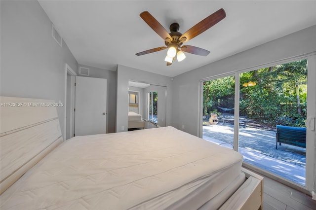 bedroom with light wood-type flooring, access to outside, and ceiling fan