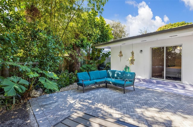 wooden deck featuring outdoor lounge area, fence, and a patio