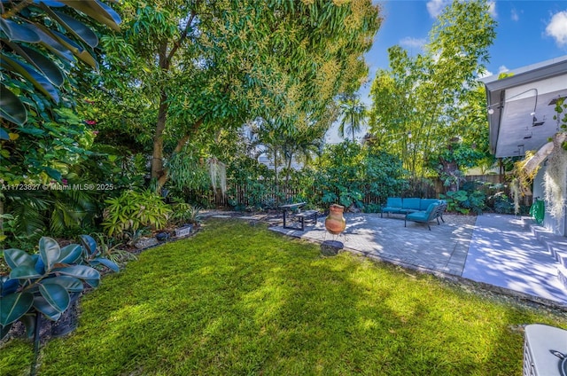 view of yard with an outdoor living space, fence private yard, and a patio area