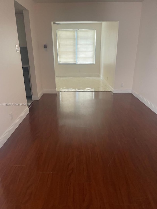 empty room featuring dark hardwood / wood-style flooring