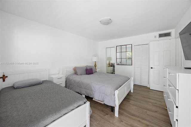 bedroom with dark hardwood / wood-style flooring