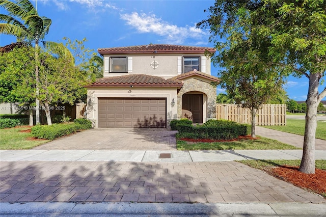 mediterranean / spanish house with a garage